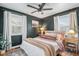 Spacious bedroom with dark green walls and plenty of natural light at 1280 Macon St, Aurora, CO 80010