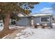 Updated gray house with snowy front yard and landscaping at 1280 Macon St, Aurora, CO 80010