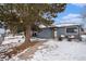 Charming gray house with snowy front yard, walkway, and landscaping at 1280 Macon St, Aurora, CO 80010