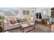 Living room with light beige couch, coffee table, and hardwood floors at 1280 Macon St, Aurora, CO 80010