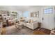 Bright living room with comfy furniture, gallery wall, and hardwood floors at 1280 Macon St, Aurora, CO 80010