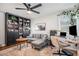 Home office with gray sectional, built-in shelving, and workspace at 1280 Macon St, Aurora, CO 80010