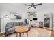 Home office with gray sectional sofa, wood coffee table, and workspace at 1280 Macon St, Aurora, CO 80010