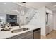 Open concept floor plan into the living room, featuring a stainless steel sink and modern finishes at 8356 W 87Th Dr # A, Arvada, CO 80005