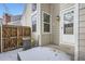 Back patio showing the corner of home, fence and air conditioner at 8356 W 87Th Dr # A, Arvada, CO 80005