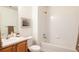 Clean bathroom with a tub, shower, and wood vanity at 5255 Memphis St # 822, Denver, CO 80239