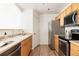 Clean kitchen with light wood cabinets and stainless steel appliances at 5255 Memphis St # 822, Denver, CO 80239