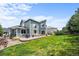 Backyard features a well-maintained lawn, a patio with seating, and attractive landscaping at 10802 W Indore Dr, Littleton, CO 80127