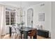Elegant dining room with modern chandelier, large window, and minimalist decor at 10802 W Indore Dr, Littleton, CO 80127