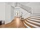 Bright foyer features wood floors, curved staircase with iron railings, and leads to a living room at 10802 W Indore Dr, Littleton, CO 80127