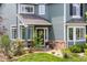 Inviting front entrance featuring a covered porch, stone accents, and manicured landscaping at 10802 W Indore Dr, Littleton, CO 80127