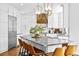 Modern kitchen with stainless steel appliances, white cabinets, and a large central island at 10802 W Indore Dr, Littleton, CO 80127