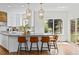 A modern kitchen featuring bar seating at the island, pendant lighting and large windows at 10802 W Indore Dr, Littleton, CO 80127