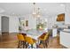 Spacious kitchen with an island, bar seating, stainless steel appliances, and hardwood floors at 10802 W Indore Dr, Littleton, CO 80127