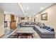 Relaxing living room with a large sectional sofa, unique coffee table, and a decorative area rug at 10802 W Indore Dr, Littleton, CO 80127