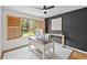 Modern office with a dark accent wall, wood shutters, contemporary desk and neutral rug at 10802 W Indore Dr, Littleton, CO 80127