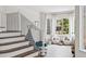 Inviting staircase sitting room with two comfy chairs, lots of light from the large windows at 10802 W Indore Dr, Littleton, CO 80127