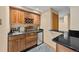 Classic wet bar features rich wood cabinetry, granite countertops, and convenient wine storage at 10802 W Indore Dr, Littleton, CO 80127