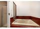 Bathroom featuring a soaking tub with red tile surround and separate shower with frosted glass door at 9400 E Iliff Ave # 88, Denver, CO 80231