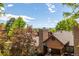 Scenic view of the property highlighting the lush landscaping and beautiful Colorado mountains beyond the rooftops at 9400 E Iliff Ave # 88, Denver, CO 80231