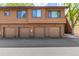 Exterior shot of garages, each with unique unit numbers and lighting fixtures, plus brown siding at 9400 E Iliff Ave # 88, Denver, CO 80231