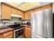 Functional kitchen features stainless steel appliances and tile countertops making cooking easy and organized at 9400 E Iliff Ave # 88, Denver, CO 80231