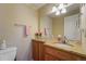 Bathroom featuring a granite countertop, honey oak cabinets, and neutral wall color at 5809 S Pearl St, Centennial, CO 80121