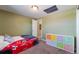 Bedroom with olive green walls, a novelty race car bed and colorful storage bins at 5809 S Pearl St, Centennial, CO 80121