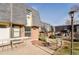 A brick townhouse with a well-maintained yard and covered entryway at 5809 S Pearl St, Centennial, CO 80121