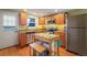 Well-equipped kitchen with an island, stainless steel appliances and hardwood flooring at 5809 S Pearl St, Centennial, CO 80121