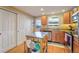 Kitchen area with an island, stainless steel appliances and hardwood flooring at 5809 S Pearl St, Centennial, CO 80121