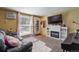 Comfortable living room featuring a white fireplace, large window and leather sofa at 5809 S Pearl St, Centennial, CO 80121