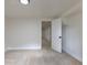 Clean basement area with new carpet leads to an open room with natural light at 6176 Ammons St, Arvada, CO 80004