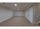 Finished basement with neutral carpeting, recessed lighting, and easy access to stairs at 6176 Ammons St, Arvada, CO 80004
