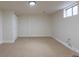 Finished basement with carpet, bright lighting, and a small window allowing natural light at 6176 Ammons St, Arvada, CO 80004