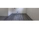 Open basement area with clean gray laminate flooring and washer/dryer hookups at 6176 Ammons St, Arvada, CO 80004