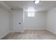 Finished basement with new neutral carpeting, white walls, and a window at 6176 Ammons St, Arvada, CO 80004