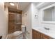 Nicely arranged bathroom showcasing a tiled shower, toilet, vanity, and other fixtures at 6176 Ammons St, Arvada, CO 80004