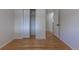 Bedroom showcasing a spacious closet, hardwood flooring, and a neutral color palette at 6176 Ammons St, Arvada, CO 80004