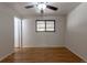 Bedroom with hardwood floors and a window overlooking the backyard at 6176 Ammons St, Arvada, CO 80004