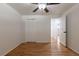 Bright bedroom featuring hardwood floors, ceiling fan, and closet at 6176 Ammons St, Arvada, CO 80004