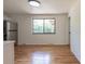 Dining room with hardwood floors, stainless refrigerator, and window overlooking the backyard at 6176 Ammons St, Arvada, CO 80004
