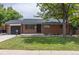 Lovely home with a well-manicured lawn, brick exterior, and attached garage at 6176 Ammons St, Arvada, CO 80004