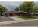 Single Gathering home featuring a dark-tone garage door and well maintained lawn at 6176 Ammons St, Arvada, CO 80004
