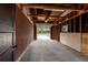 Spacious two-car garage with exposed ceiling and brick walls provides ample storage at 6176 Ammons St, Arvada, CO 80004