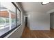 Hallway featuring hardwood floors, access to the porch, and a glimpse of the bathroom at 6176 Ammons St, Arvada, CO 80004