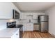 Modern kitchen featuring stainless steel appliances, white cabinets, and stylish countertops at 6176 Ammons St, Arvada, CO 80004
