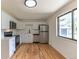Bright kitchen featuring white cabinets and stainless steel appliances at 6176 Ammons St, Arvada, CO 80004
