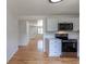 Kitchen space showcasing bright, new cabinets and light hardwood floors at 6176 Ammons St, Arvada, CO 80004