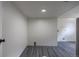 Bright laundry room with new gray laminate flooring and white walls at 6176 Ammons St, Arvada, CO 80004